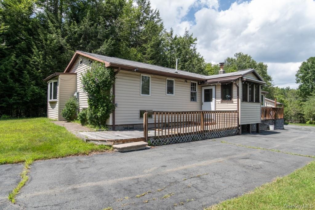 139 Haddock Road Monticello, NY 12701 - Photo 3 of 40 Ranch-style home with a wooden deck and a front yard