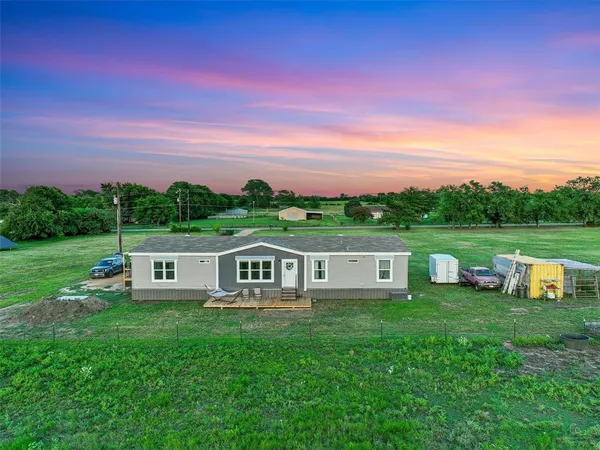 a view of a house with a big yard