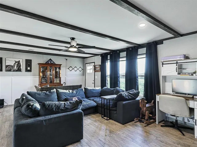 a living room with furniture and a large window