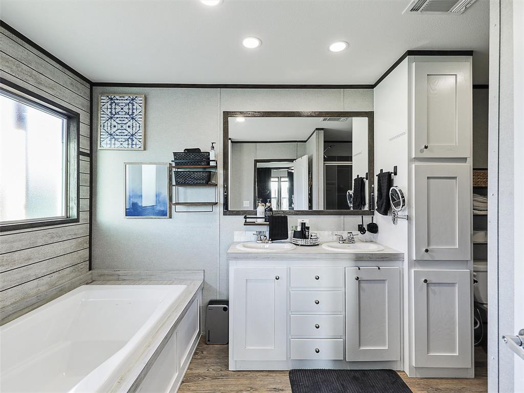 2149 Webb Smith Road Sherman, TX 75090 - Photo 13 of 39 a bathroom with a tub a sink and a large mirror