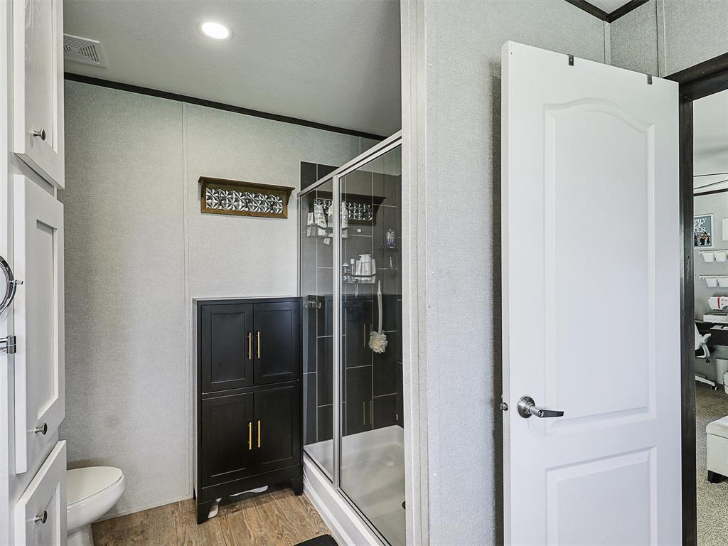 2149 Webb Smith Road Sherman, TX 75090 - Photo 14 of 39 a bathroom with a shower and a toilet