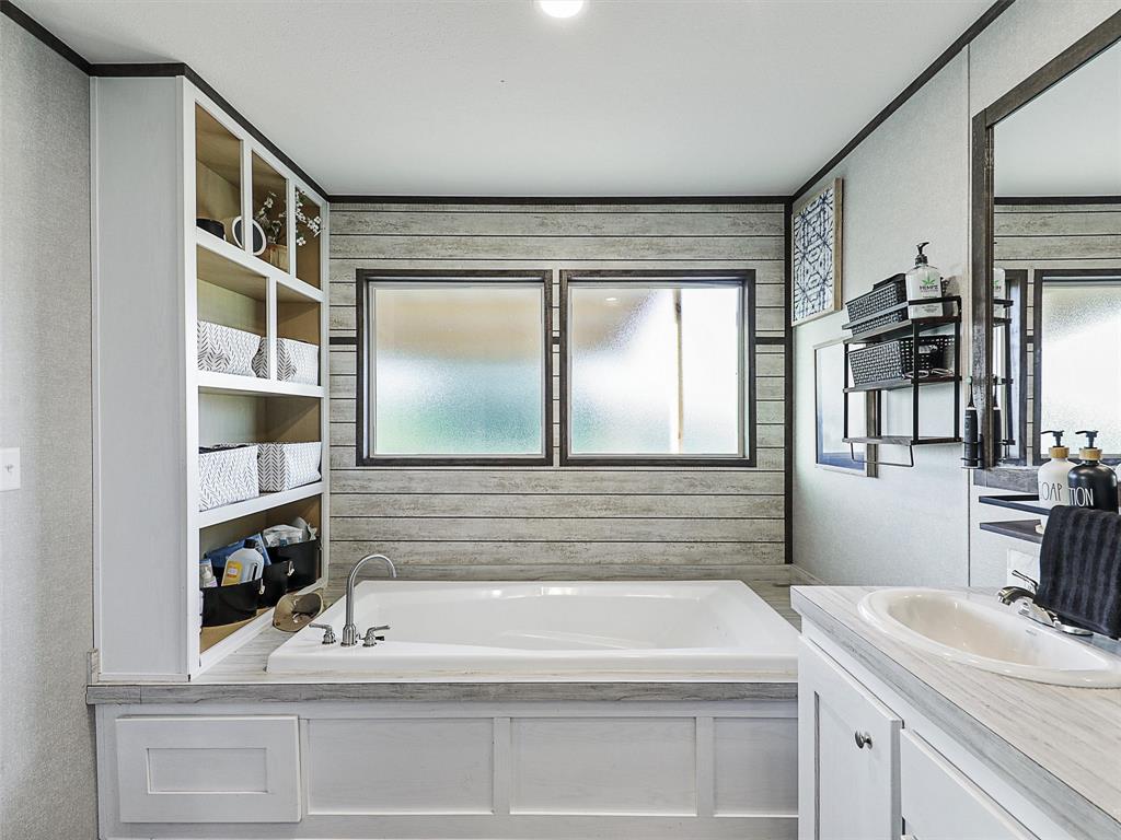 2149 Webb Smith Road Sherman, TX 75090 - Photo 15 of 39 a bathroom with a sink and a mirror