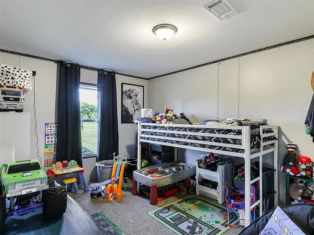 a living room with lots of furniture and a baby crib