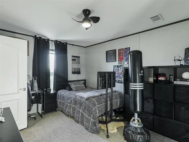 a bedroom with a bed closet and flat tv screen