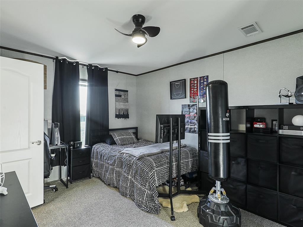 2149 Webb Smith Road Sherman, TX 75090 - Photo 19 of 39 a bedroom with a bed closet and flat tv screen