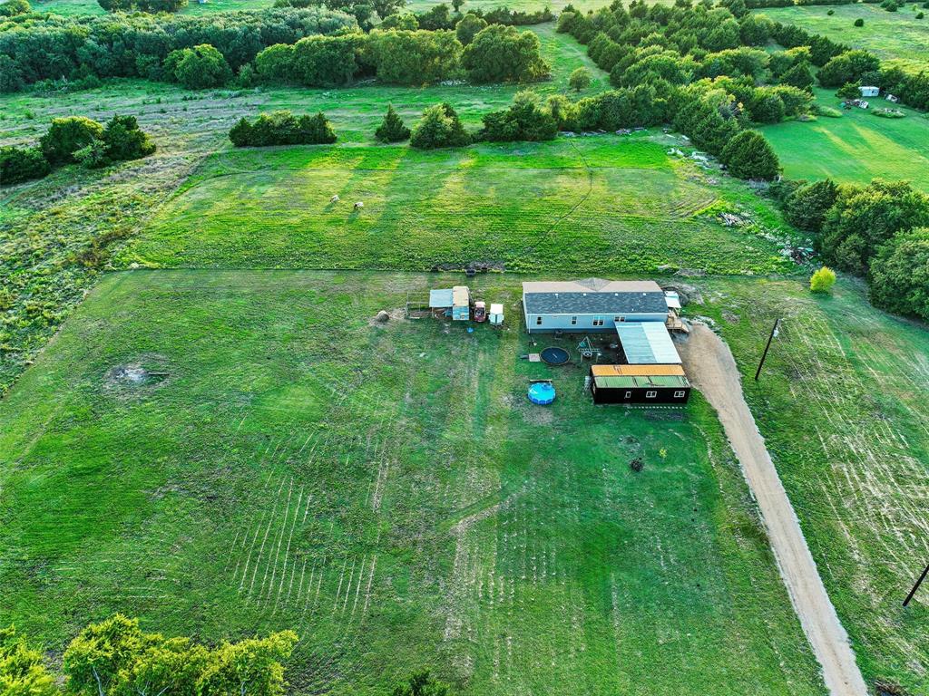 2149 Webb Smith Road Sherman, TX 75090 - Photo 26 of 39 a view of a backyard with lawn chairs and large trees