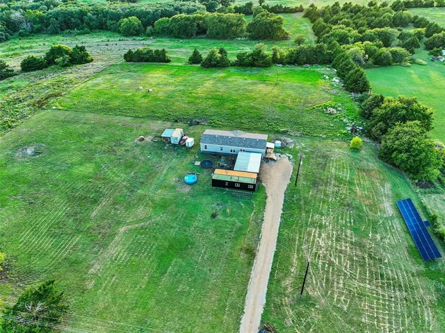 a backyard of a house with a yard and outdoor seating