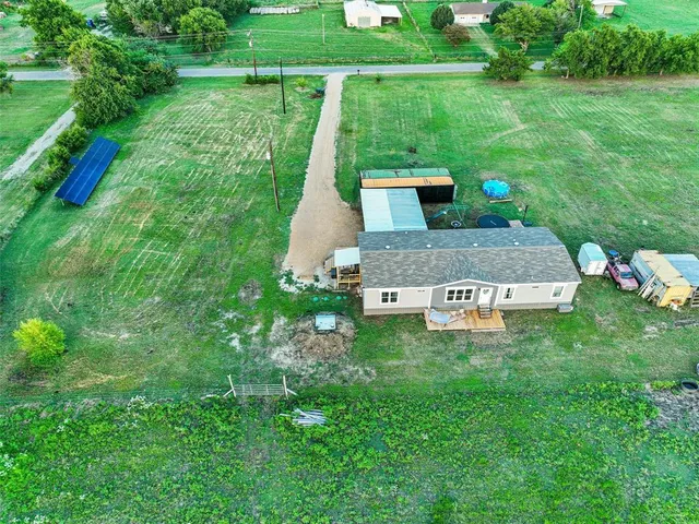 a view of a garden with a bench sitting area