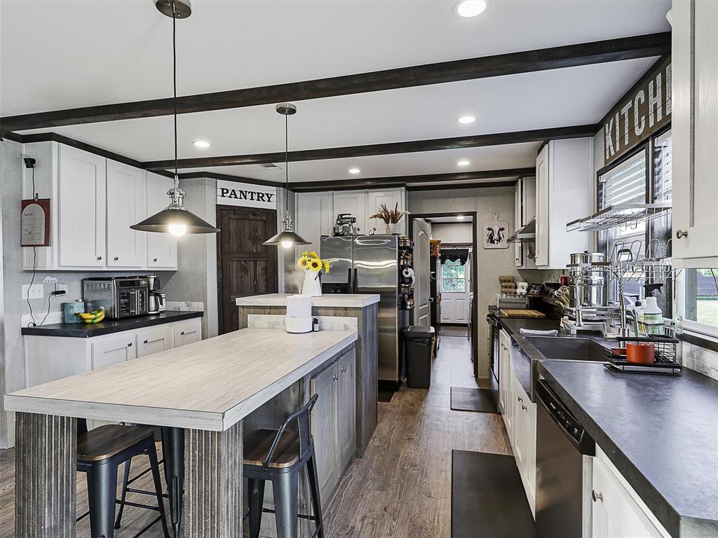 2149 Webb Smith Road Sherman, TX 75090 - Photo 4 of 39 a kitchen with stainless steel appliances granite countertop a sink a stove and refrigerator