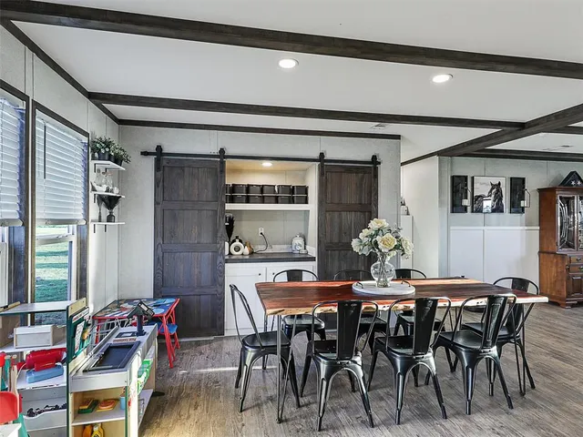a dining room with furniture and window