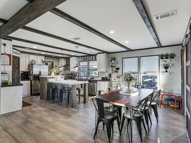 a view of a dining room with furniture and a livingroom