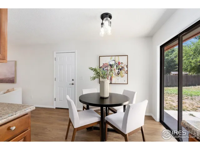 a dining room with furniture and wooden floor