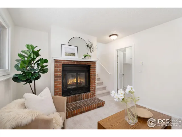 a living room with furniture chandelier and a fireplace
