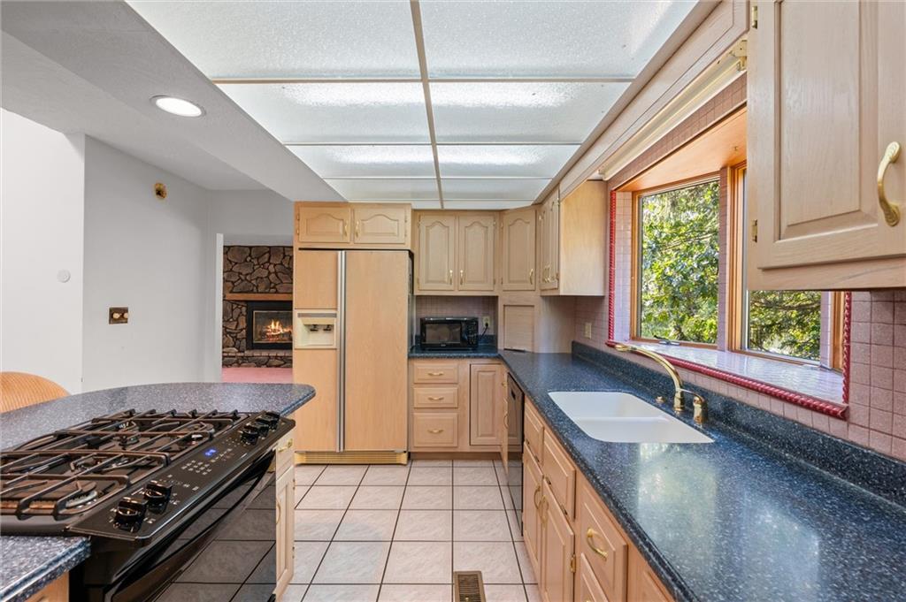 1164 River Road Freeport, PA 16229 - Photo 13 of 50 a kitchen with a stove a sink and a refrigerator