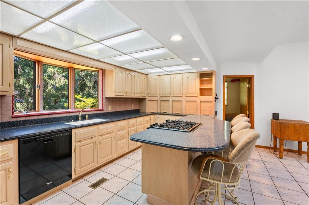 1164 River Road Freeport, PA 16229 - Photo 14 of 50 a kitchen with stainless steel appliances granite countertop a stove a sink dishwasher and a microwave oven with cabinets