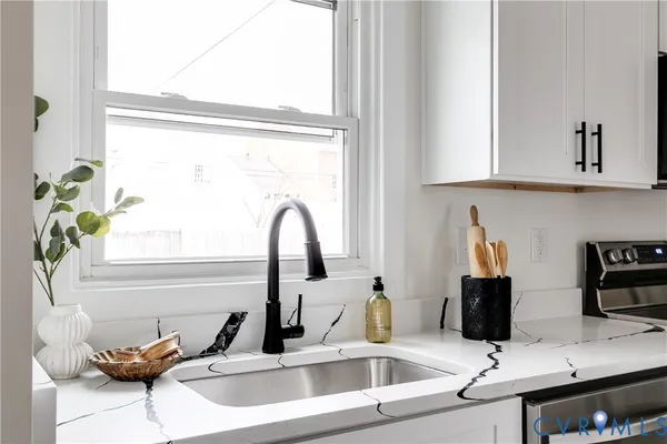 a bathroom with a sink and a window
