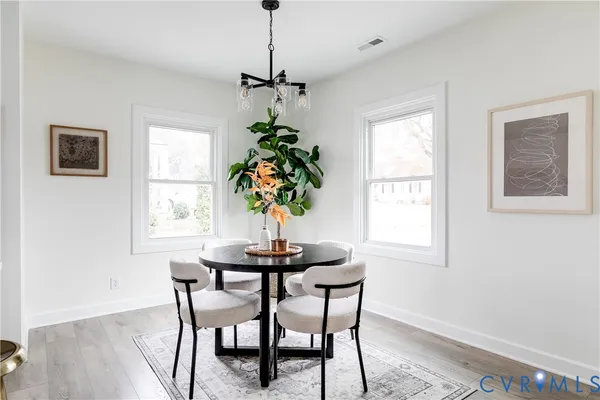 a dining room with furniture and window