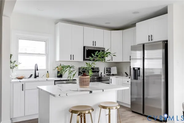 a kitchen with a refrigerator and a sink