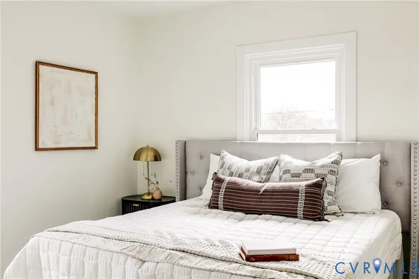 a bedroom with a bed and a window