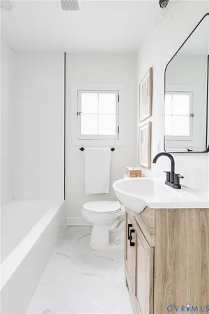 a bathroom with a sink a toilet and a bathtub