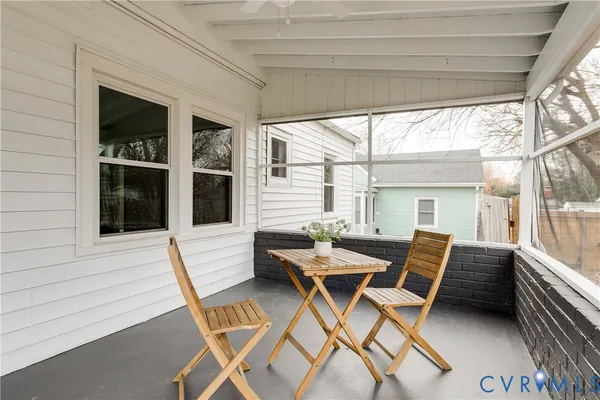 a patio with yard glass top table and chairs
