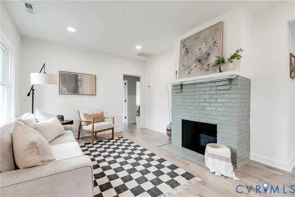 a living room with furniture and a fireplace