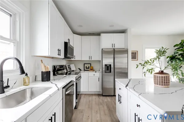 a kitchen with a sink stove and refrigerator
