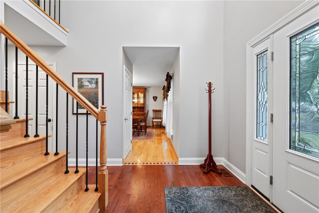 4568 Greenfield Road Bethlehem, PA 18017 - Photo 4 of 59 A graceful staircase with intricate balusters welcomes you into this inviting entryway, featuring polished hardwood floors.