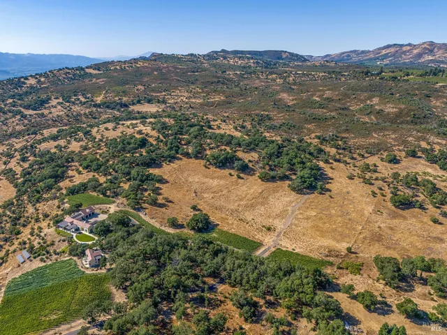 an aerial view of mountain with residential space and trees