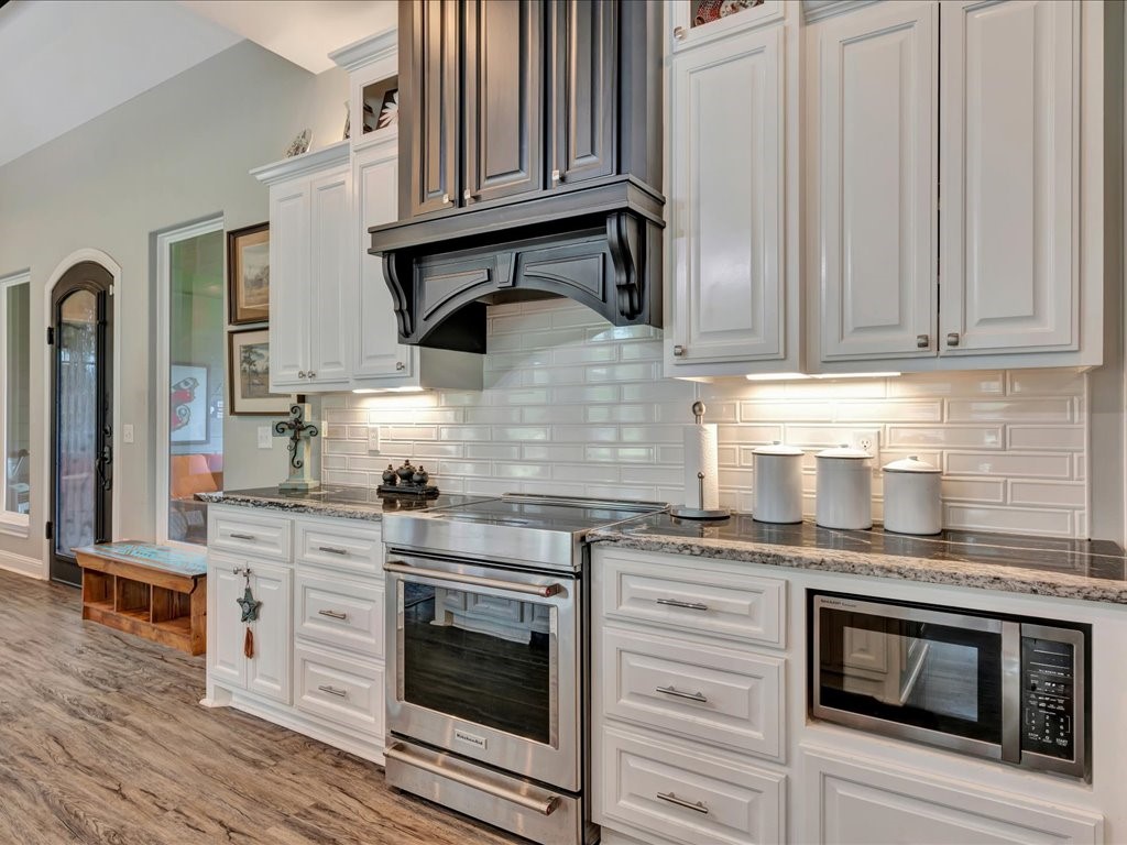 104 Wheeler Road Lufkin, TX 75901 - Photo 16 of 45 a kitchen with stainless steel appliances granite countertop a stove microwave and cabinets