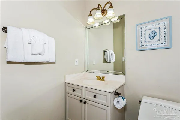 a bedroom with a bed a dresser and a large window