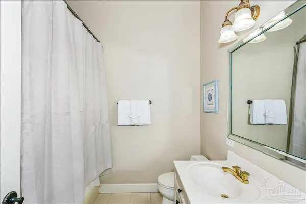 a white toilet sitting next to a bathroom sink