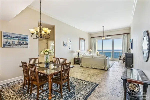 a living room with furniture a flat screen tv and a floor to ceiling window