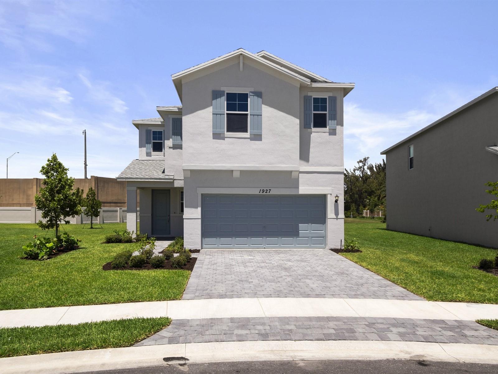 1927 Harding Street Lake Worth, FL 33460 - Photo 1 of 19 a front view of a house with a yard and garage