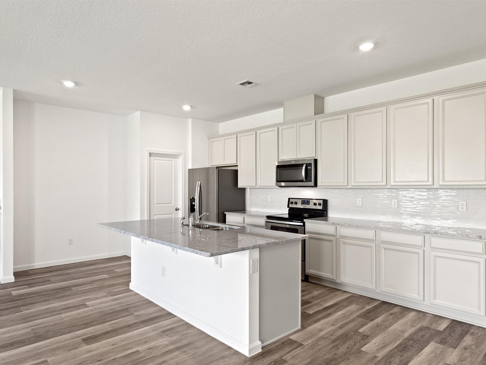 1927 Harding Street Lake Worth, FL 33460 - Photo 3 of 19 a kitchen with stainless steel appliances granite countertop a sink stove and refrigerator