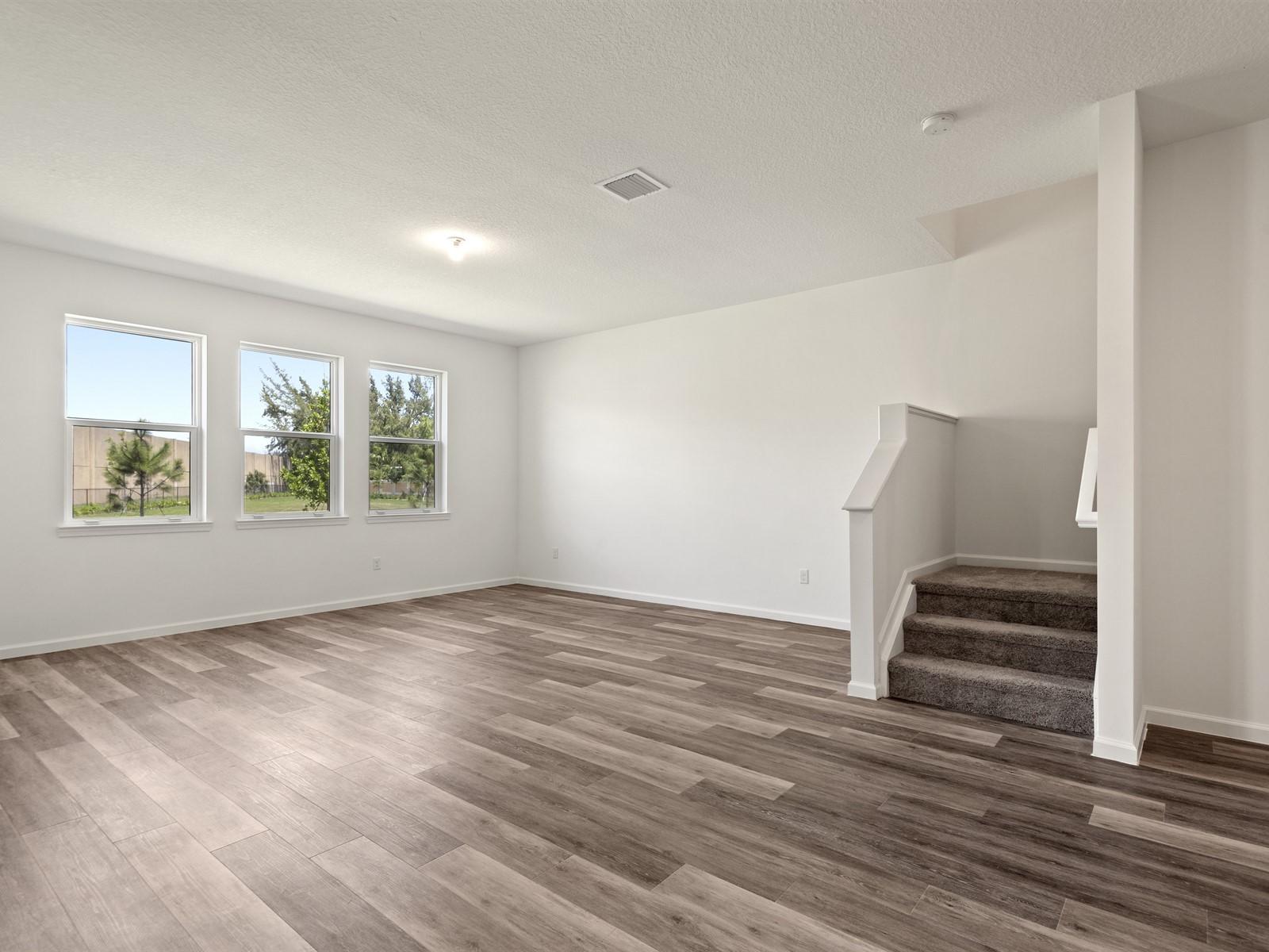 1927 Harding Street Lake Worth, FL 33460 - Photo 7 of 19 wooden floor in an empty room with a window