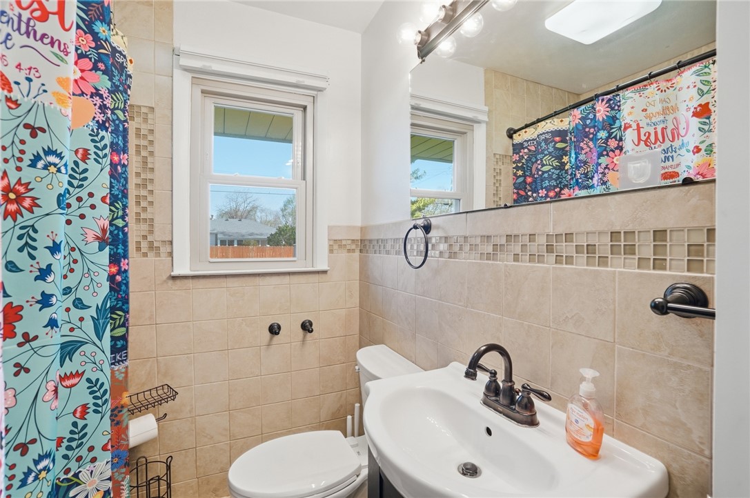 1325 Chelsea Road Troy, OH 45373 - Photo 22 of 42 This bathroom features a contemporary sink and toilet, accented by elegant tile work.