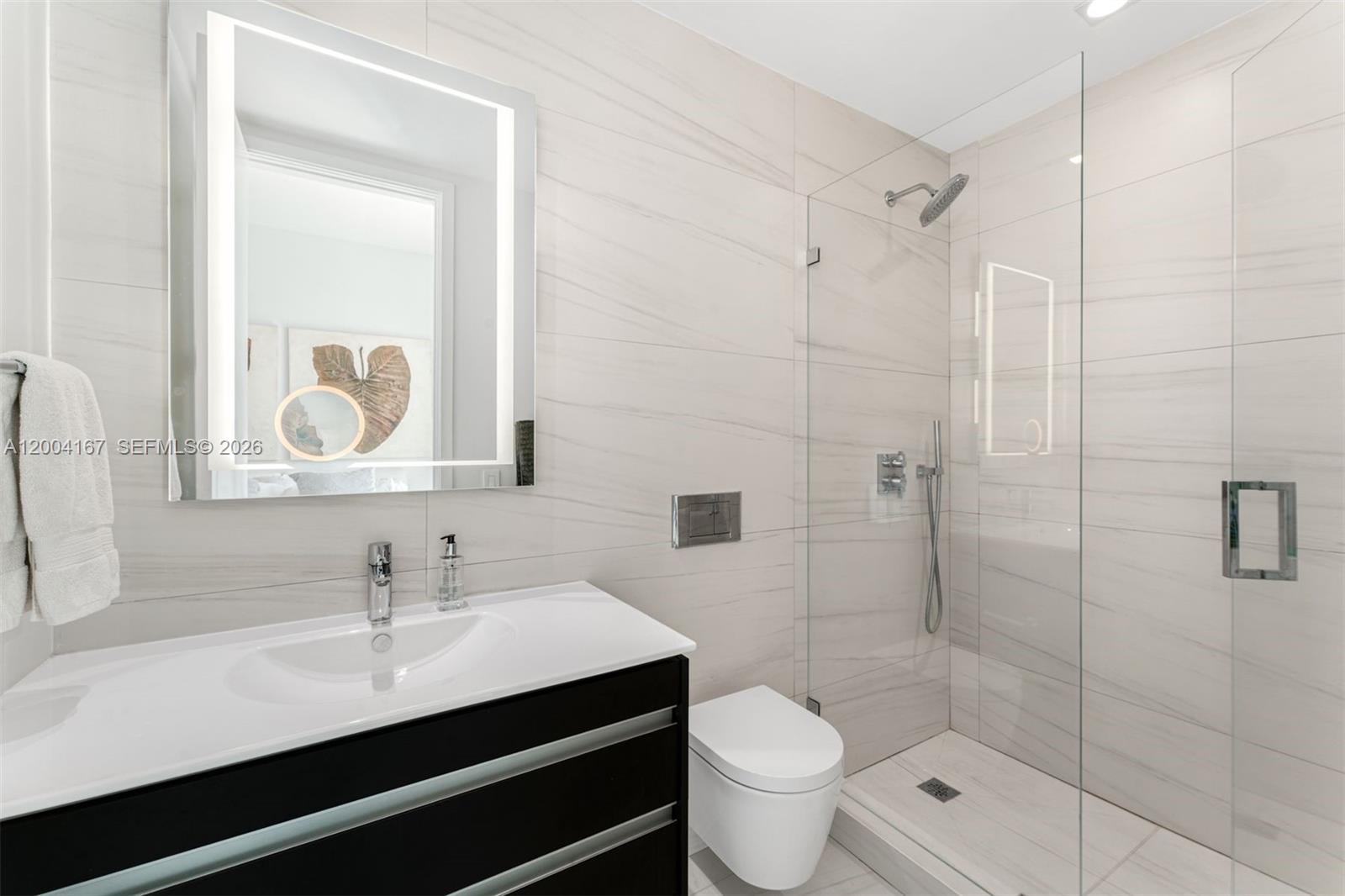 1723 Southwest 2nd Avenue, Unit PH2 Miami, FL 33129 - Photo 11 of 18 a bathroom with a sink a toilet and shower