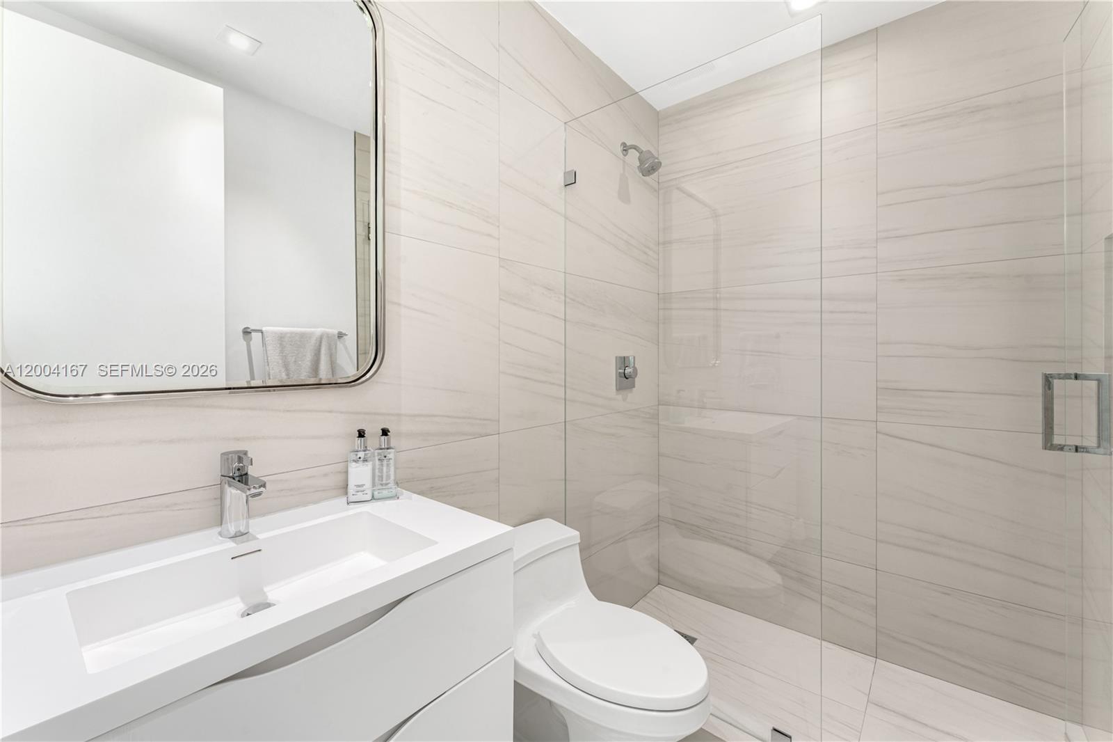 1723 Southwest 2nd Avenue, Unit PH2 Miami, FL 33129 - Photo 13 of 18 a bathroom with a sink a toilet and shower