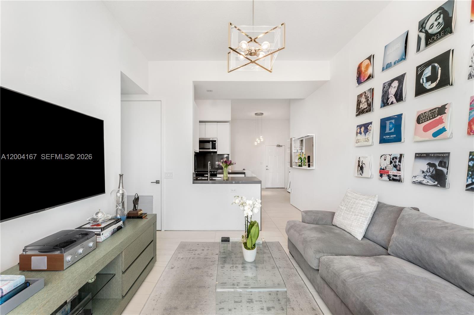 1723 Southwest 2nd Avenue, Unit PH2 Miami, FL 33129 - Photo 3 of 18 a living room with furniture and a flat screen tv