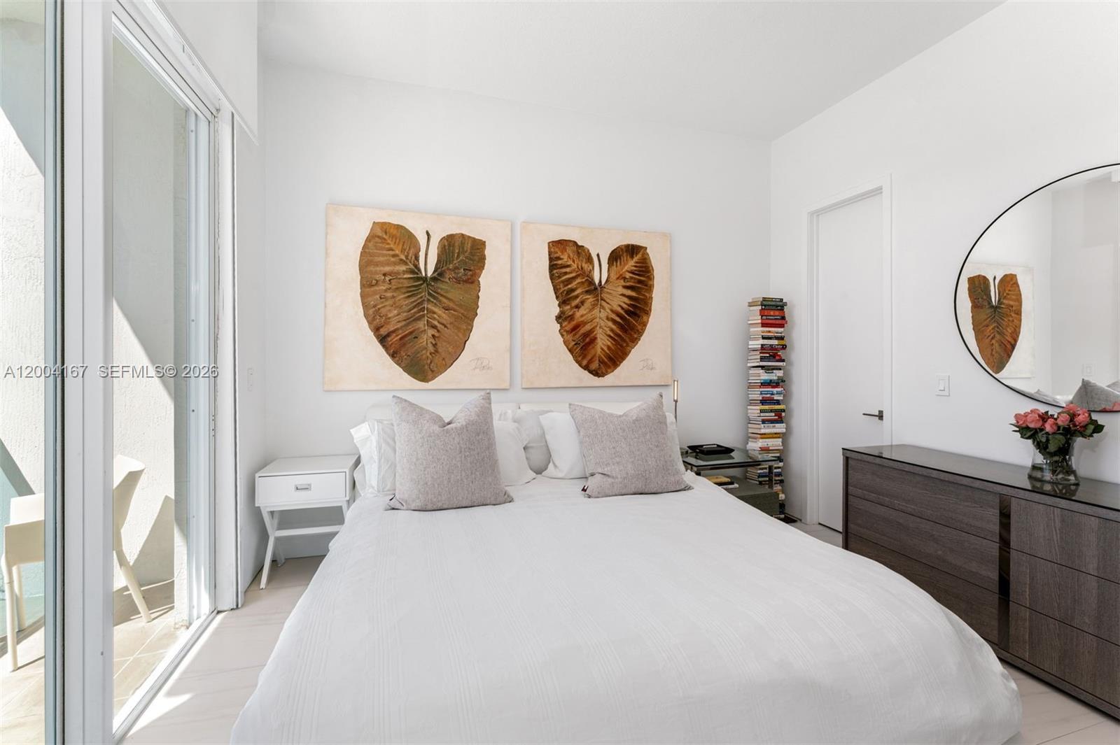 1723 Southwest 2nd Avenue, Unit PH2 Miami, FL 33129 - Photo 8 of 18 a bedroom with a bed and a chandelier