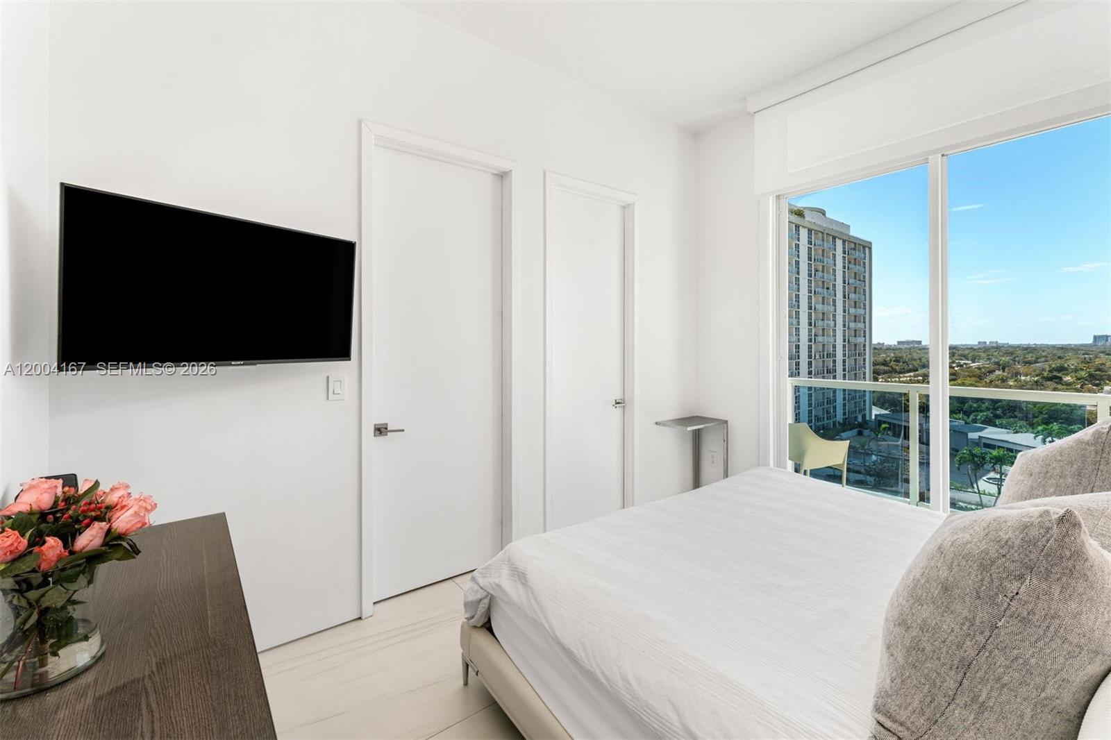 1723 Southwest 2nd Avenue, Unit PH2 Miami, FL 33129 - Photo 9 of 18 a bedroom with a bed and a flat screen tv