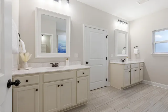 a bathroom with a double vanity sink and mirror