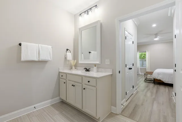 a spacious bathroom with a double vanity sink and a mirror