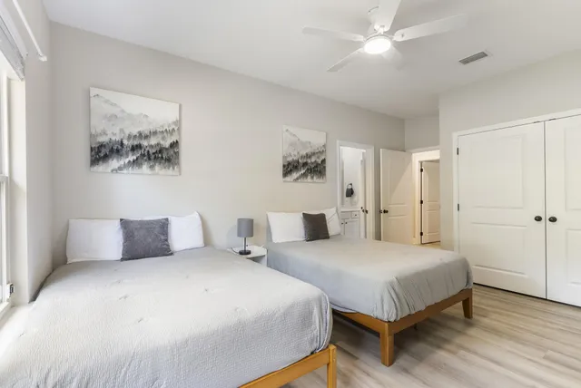 a bedroom with a bed and a painting on the wall