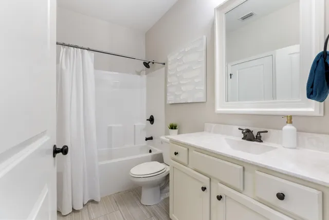 a bathroom with a sink a toilet and a bathtub
