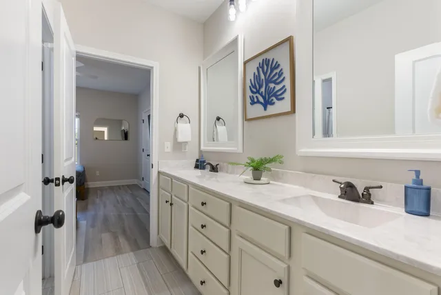 a bathroom with a granite countertop sink and a mirror