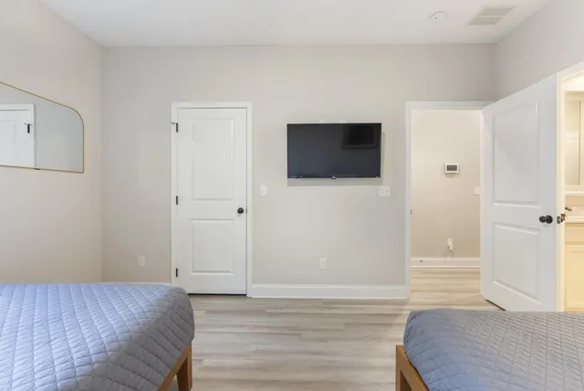 a bedroom with a bed and a flat screen tv