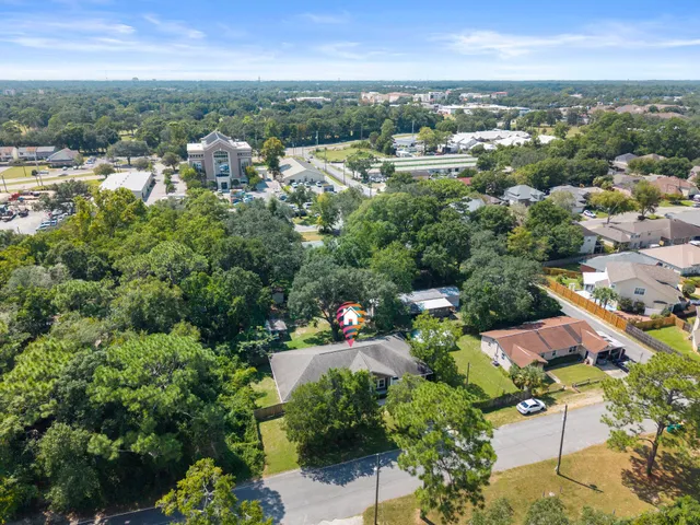 an aerial view of a houses with a yard