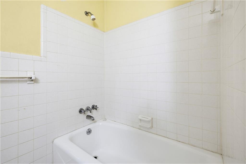4188 Cedar Valley Lane Conley, GA 30288 - Photo 15 of 28 a white bath tub sitting in a bathroom
